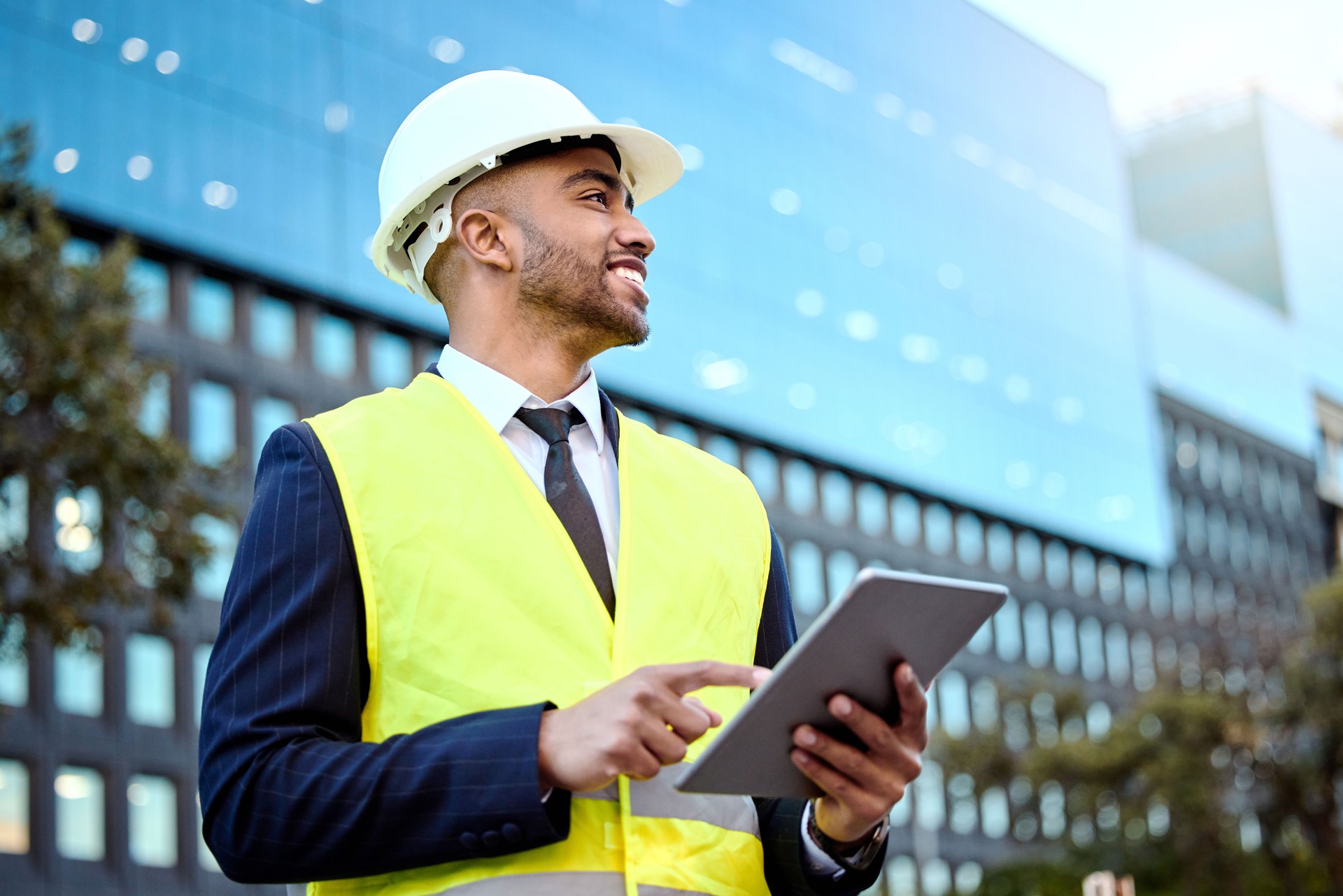 Shot of a young businessman on a construction site using a digital tablet