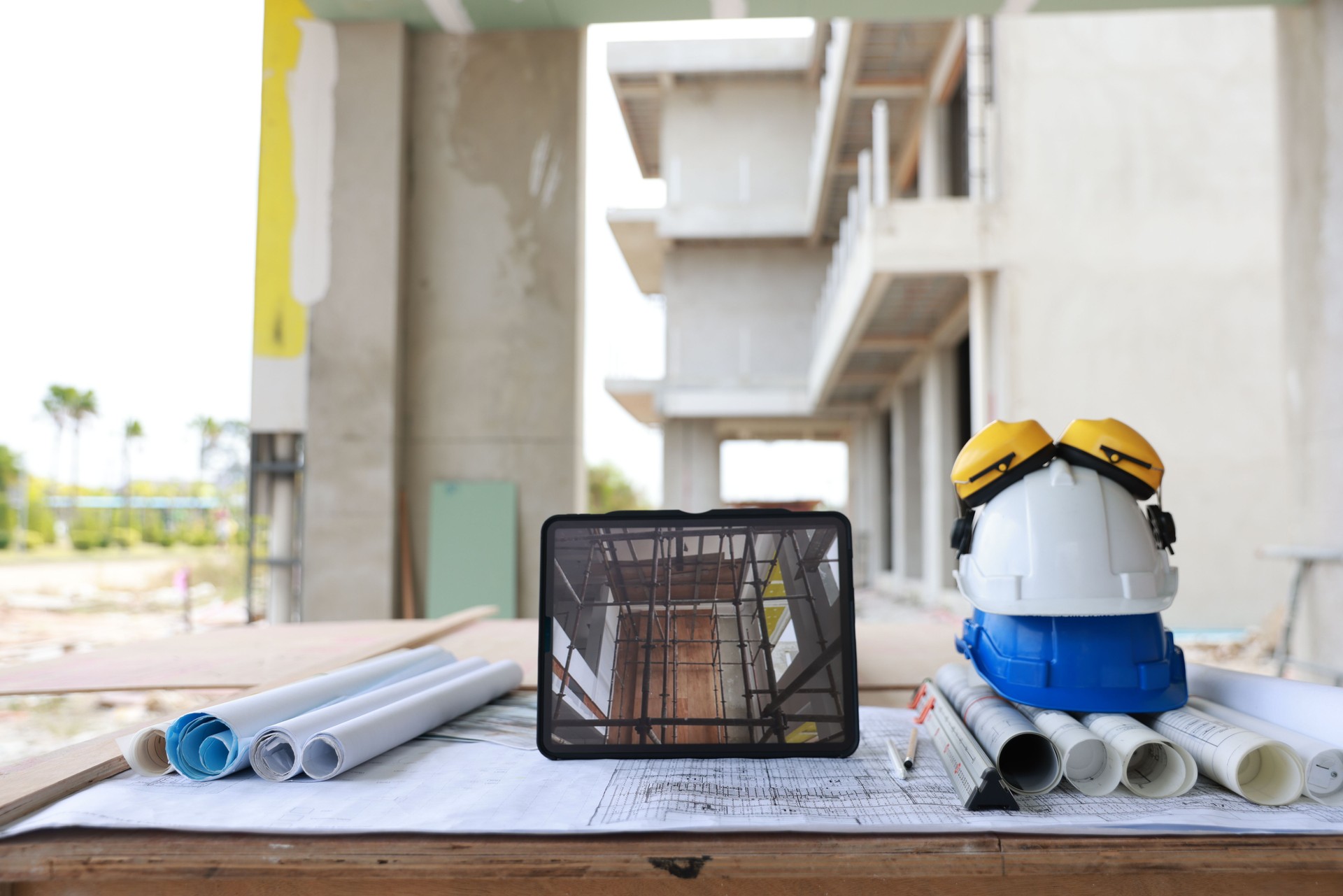 Construction equipment. Home and Building construction , laptop on drawing and safety hardhat at construction site